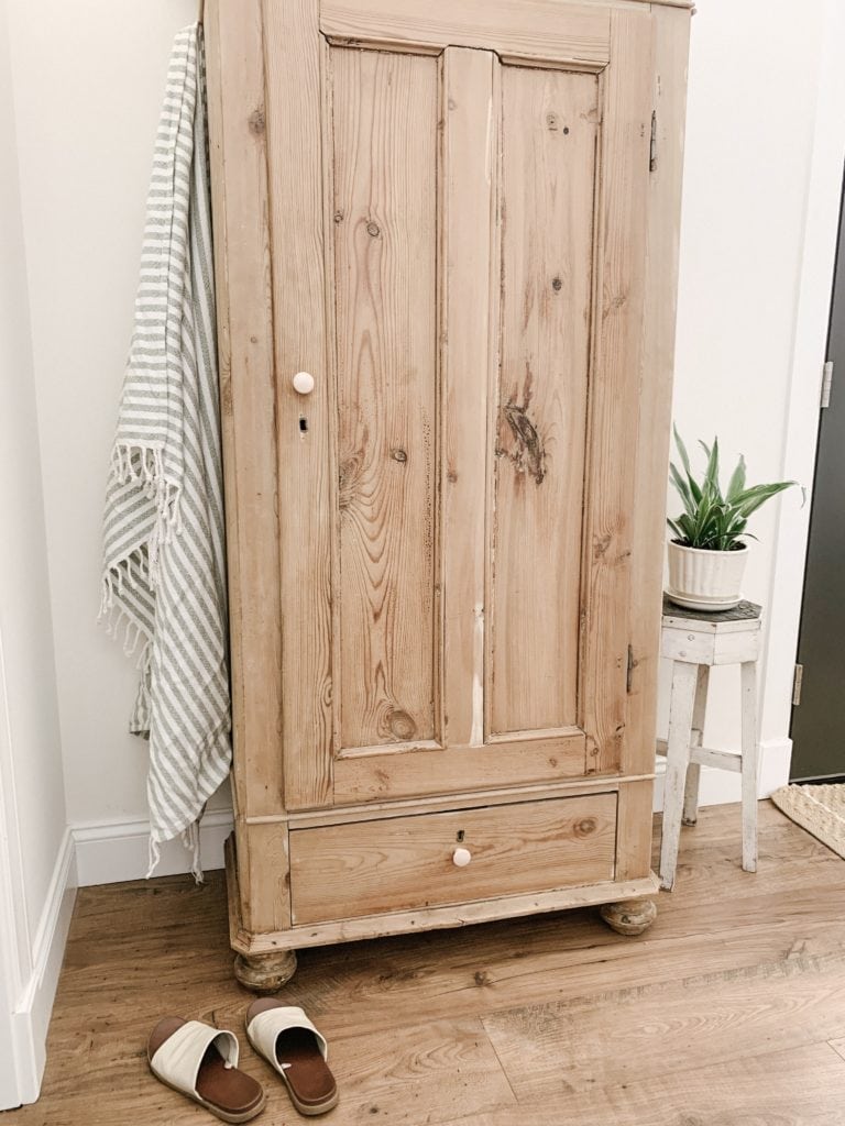 antique cabinet used in entryway for storage