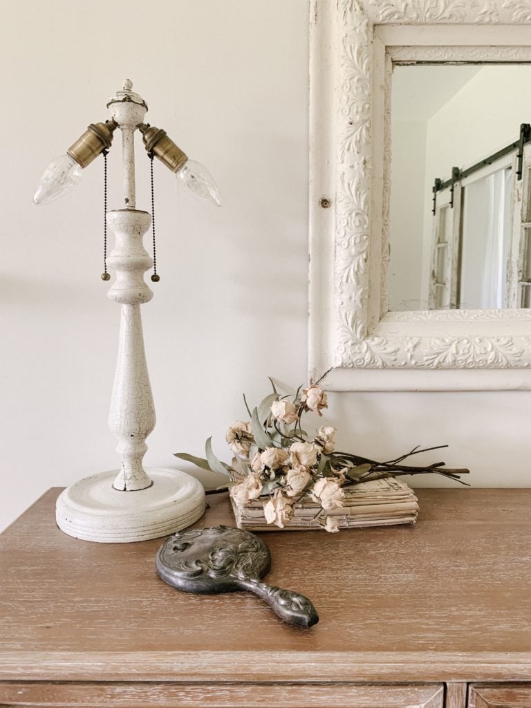 handheld mirror and dried roses displayed for home decor
