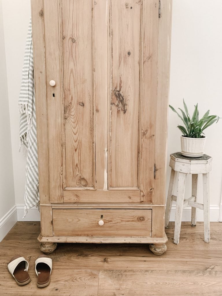 old pine cabinet used in entryway for storage and function