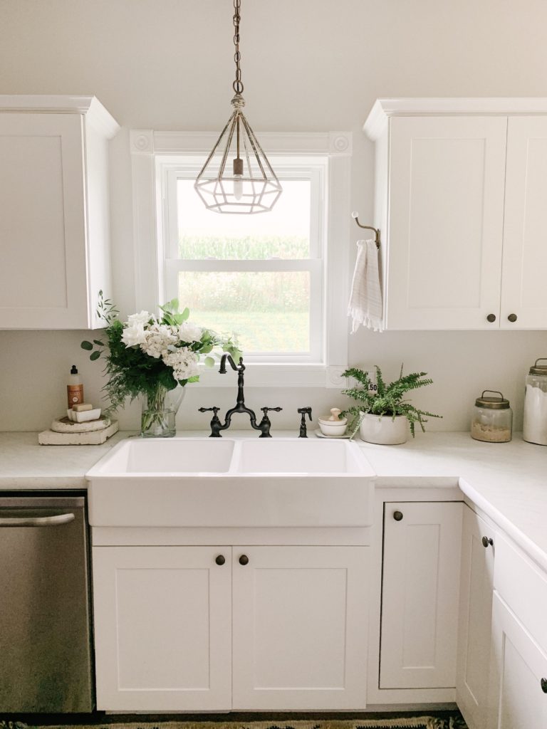 white farmhouse kitchen with brass and black accents
