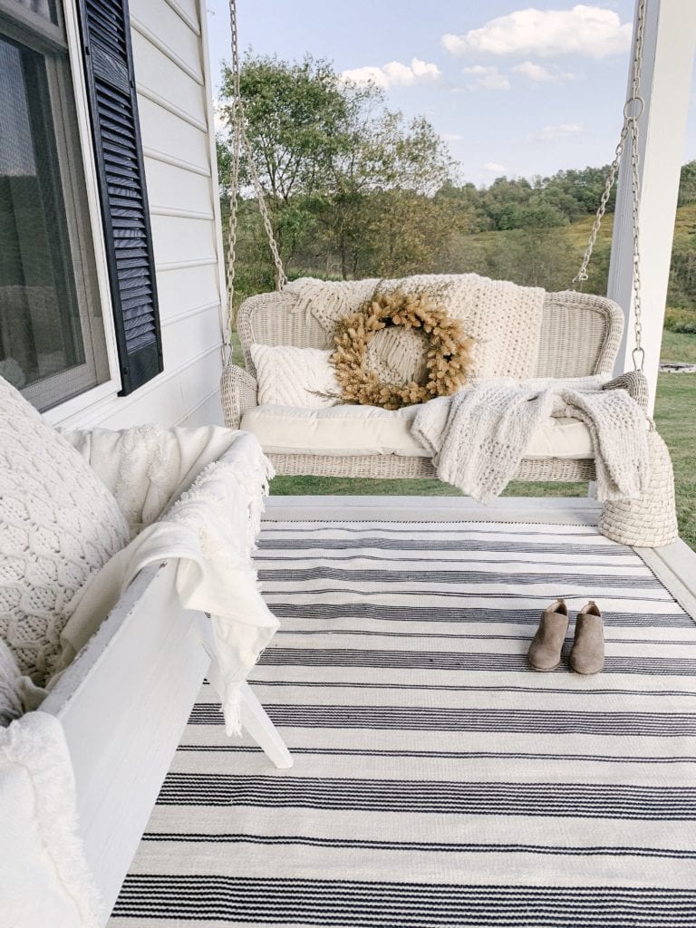 wrap around front porch with neutral porch swing
