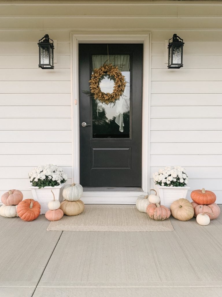 fall front porch decor with white mums and colorful pumpkins