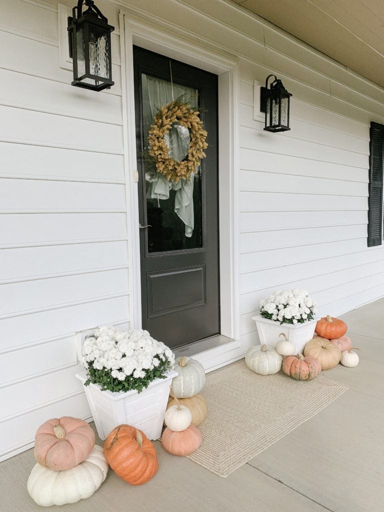 orange white yellow blue pumpkins used for fall porch decor