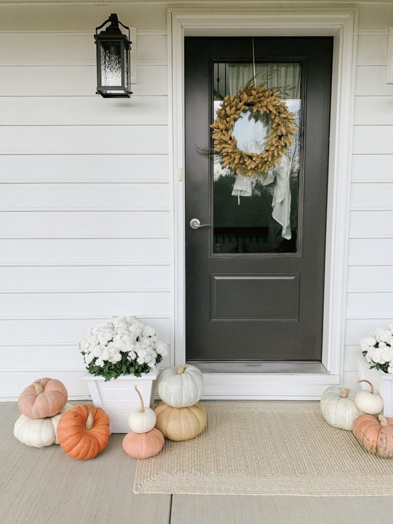 displaying pumpkins outside of front door for autumn decor