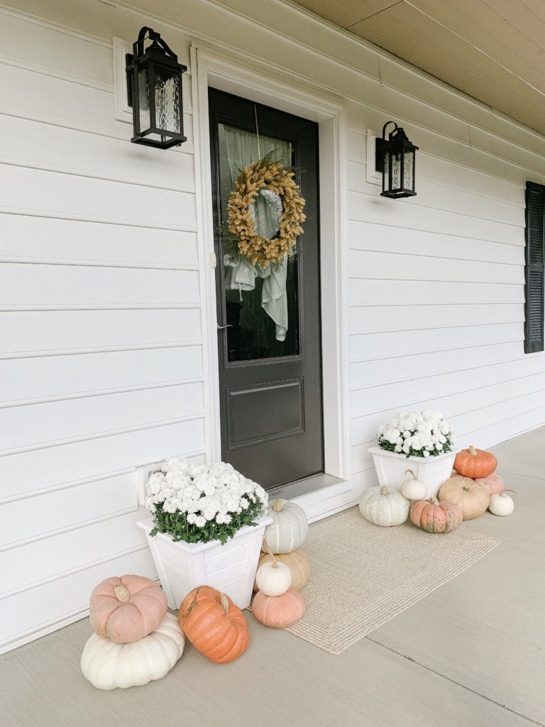 farmhouse fall front porch decor ideas with colorful pumpkins
