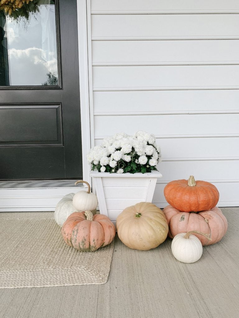 stacked pumpkins on front porch for fall