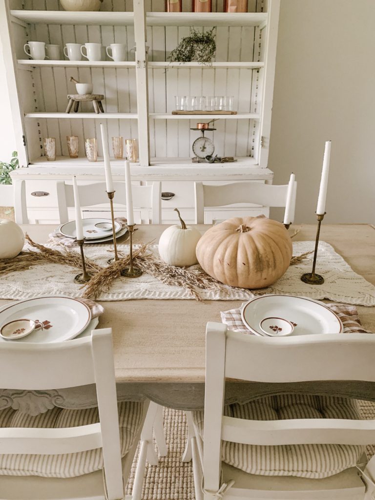 muted orange and white pumpkins with wheat used on tablescape