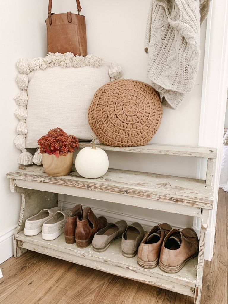 round knit pillow from target and tassel cream pillow on shoe bench in cozy autumn entryway