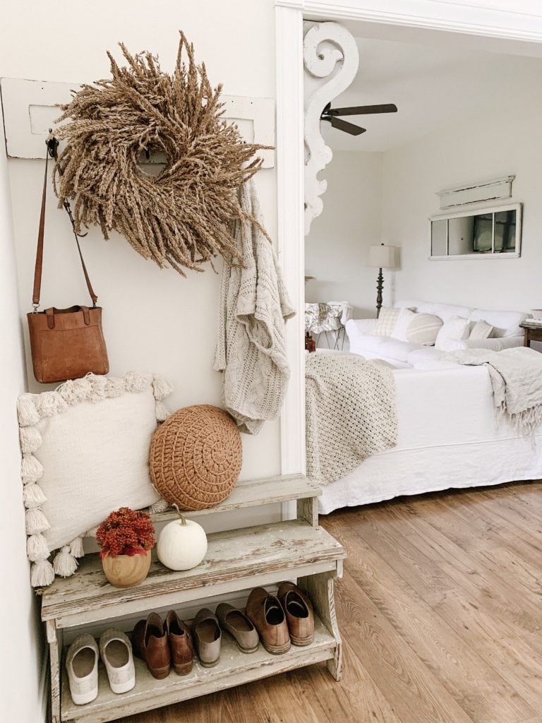 shoe rack in foyer decorated for fall