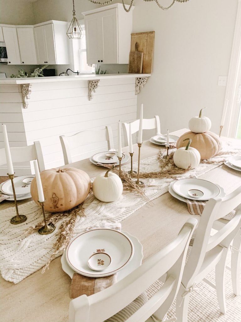 simple thanksgiving tablescape with wheat brass candlesticks vintage stoneware and pumpkins