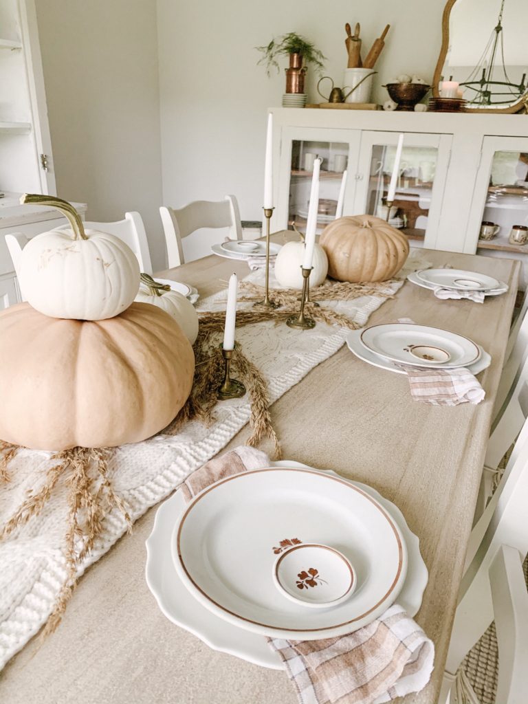 neutral fall tablescape using pumpkins vintage stoneware wheat and antique candleholders