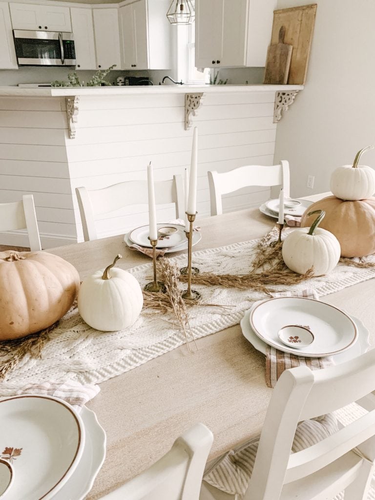 muted orange and white pumpkins used on dining table centerpiece