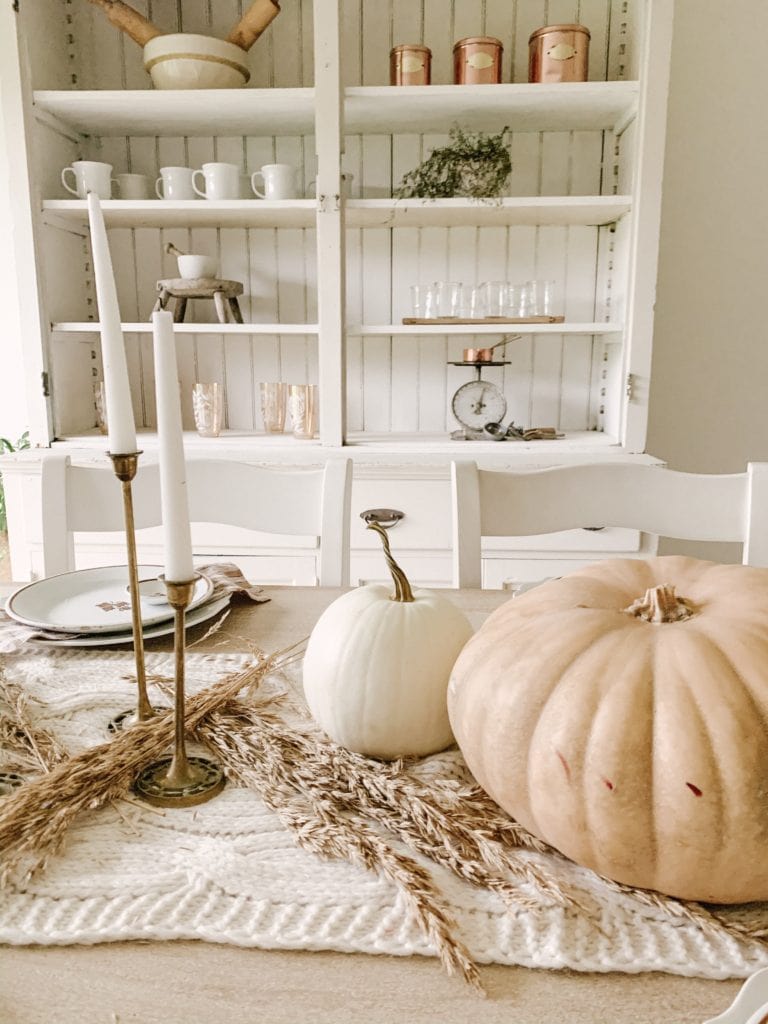 wheat and pumpkins on dining room table