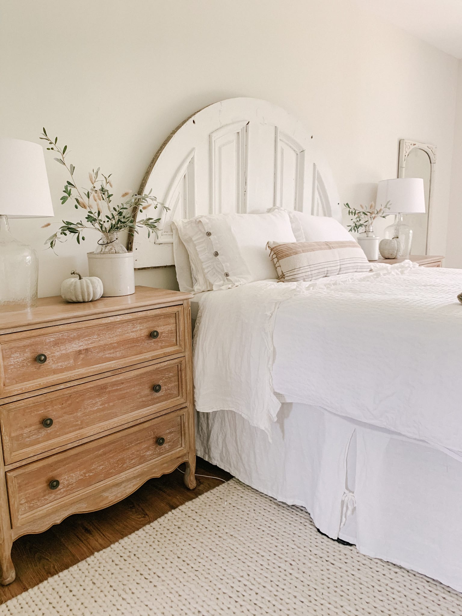 neutral farmhouse bedroom decorated for summer and fall