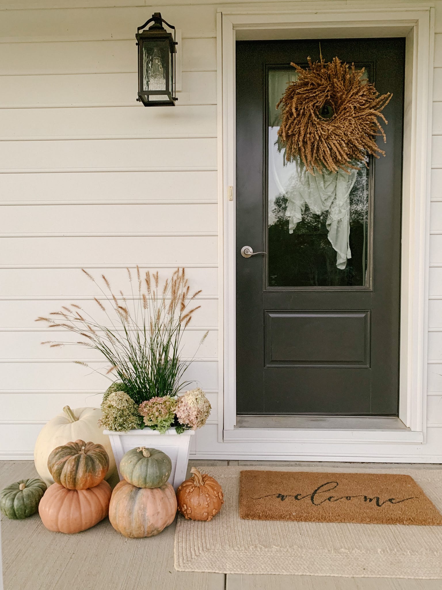 grass and dried hydrangeas on fall front porch