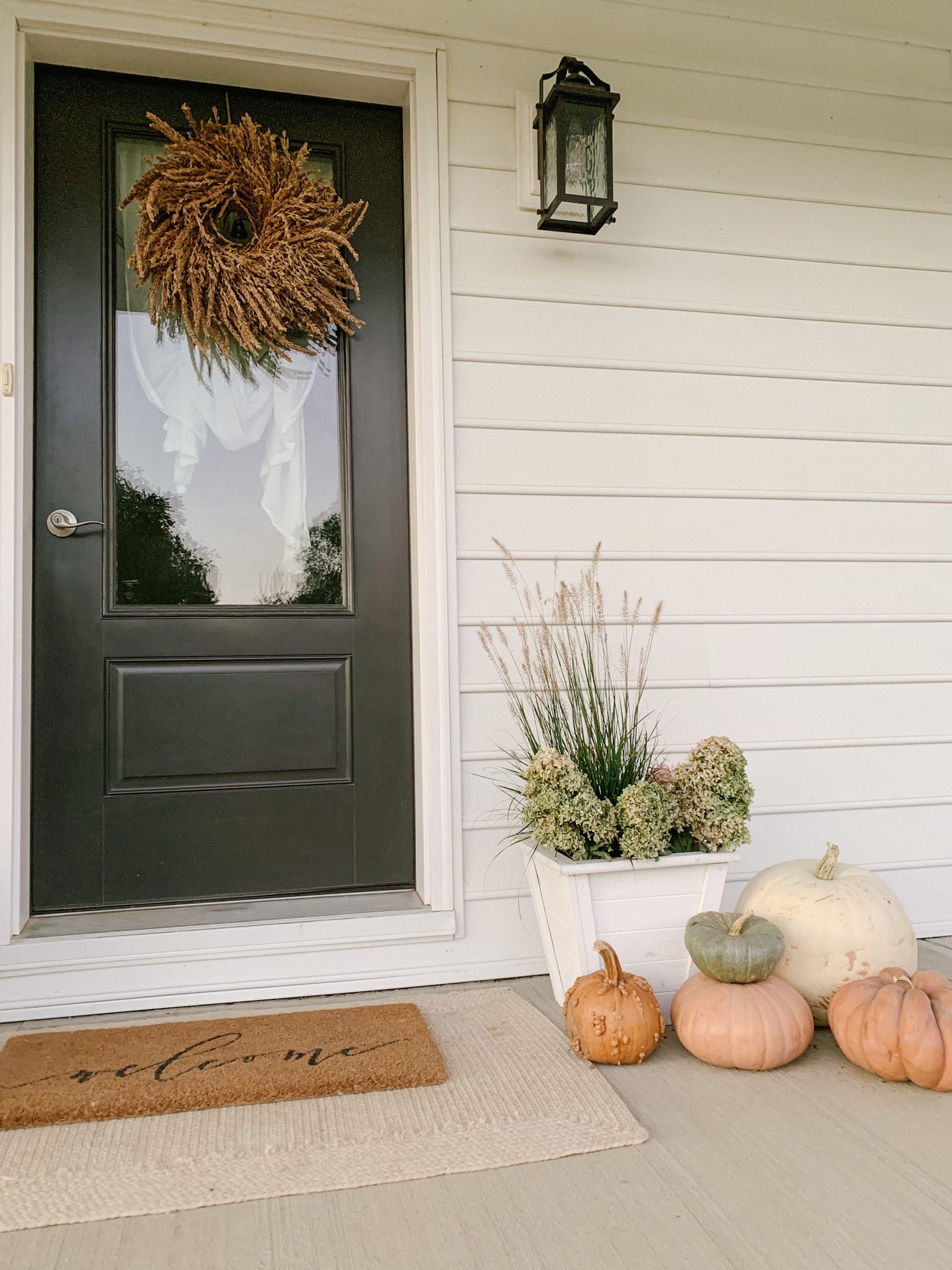 grass and pumpkins porch decor for fall