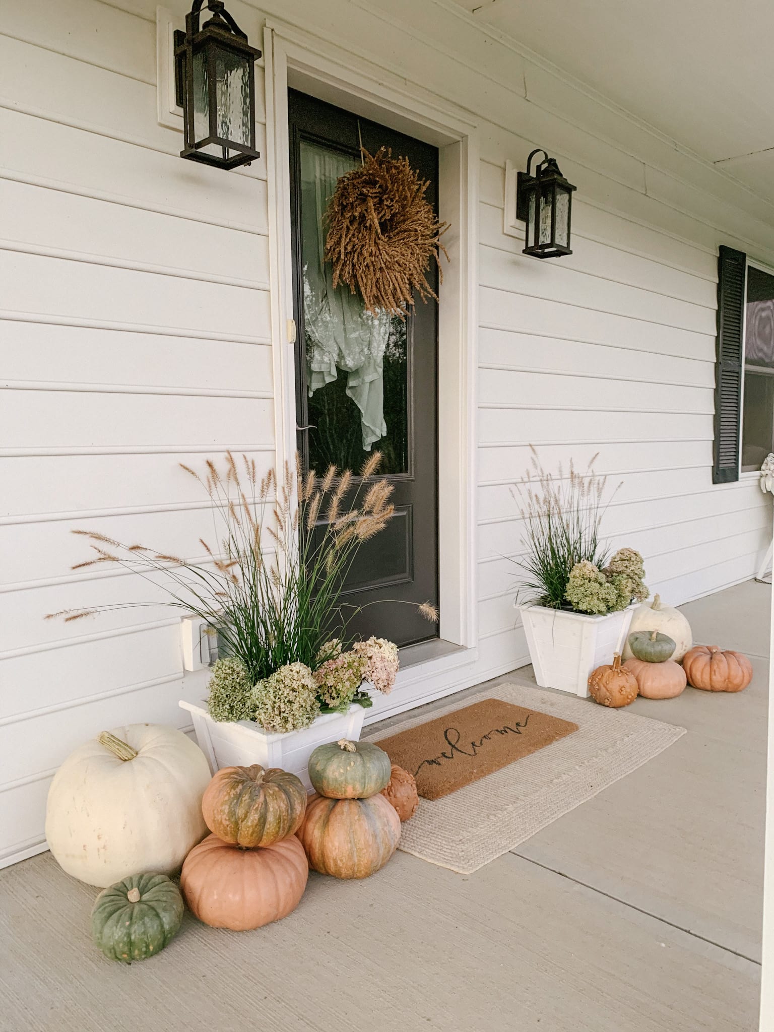 muted porch decor using unique pumpkins on porch